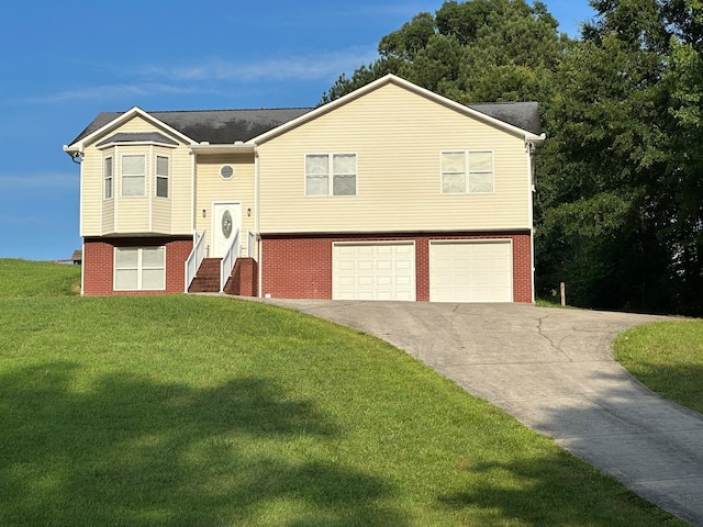 740 Grassy Branch Rd, Dayton, TN 37321 - split foyer home with an attached garage, concrete driveway, a front yard, brick siding, and entry steps