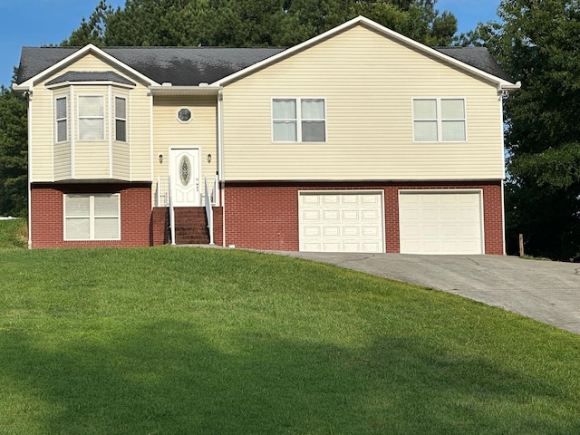 740 Grassy Branch Rd, Dayton, TN 37321 - raised ranch with a garage, driveway, brick siding, and a front lawn