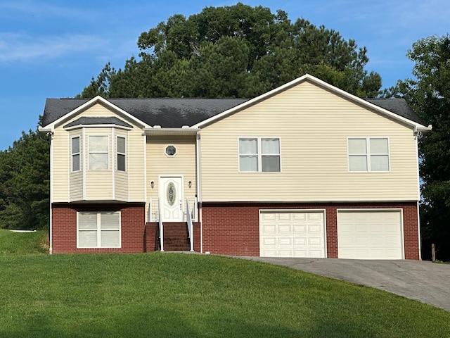 740 Grassy Branch Rd, Dayton, TN 37321 - split foyer home with asphalt driveway, an attached garage, a front lawn, and brick siding