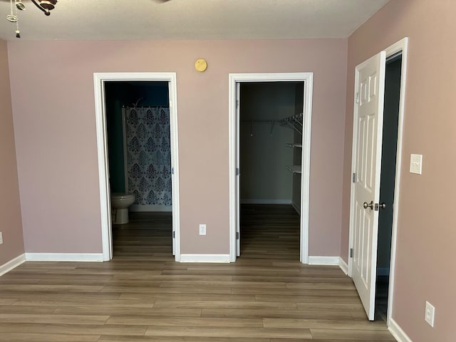 740 Grassy Branch Rd, Dayton, TN 37321 - unfurnished bedroom with light wood-style flooring, a walk in closet, and ensuite bathroom