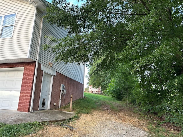 740 Grassy Branch Rd, Dayton, TN 37321 - view of side of property featuring an attached garage and brick siding