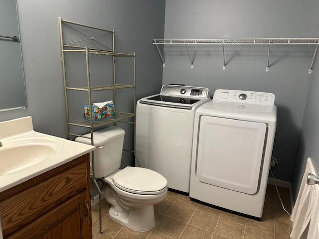 740 Grassy Branch Rd, Dayton, TN 37321 - half bath with independent washer and dryer, vanity, and tile patterned floors