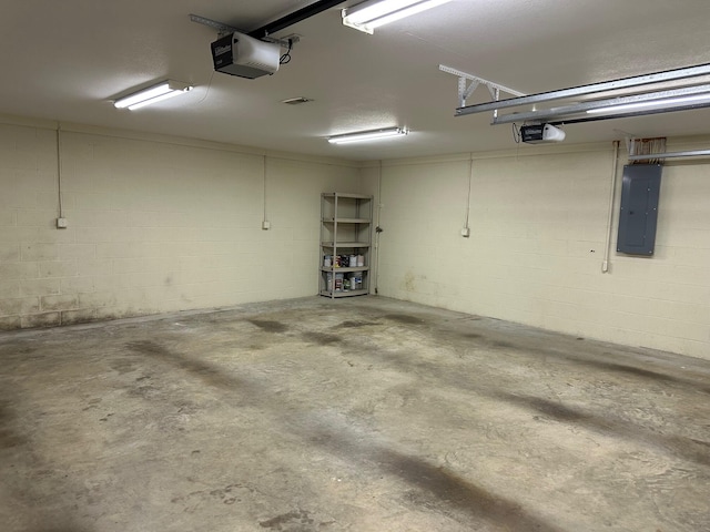 740 Grassy Branch Rd, Dayton, TN 37321 - garage featuring electric panel, a garage door opener, and concrete block wall
