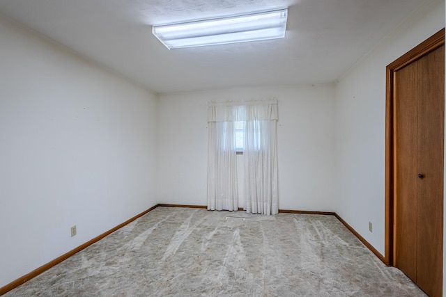 unfurnished room with light carpet