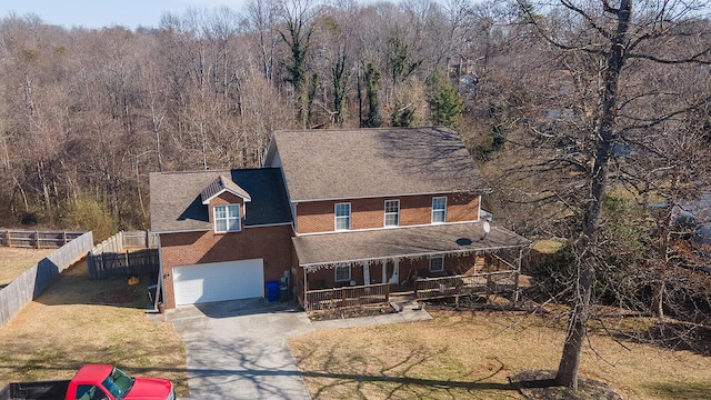 123 Carson Pl, Clinton, TN 37716 - view of front of house featuring covered porch, driveway, an attached garage, a view of trees, and a shingled roof