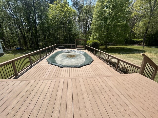 wooden deck with a lawn