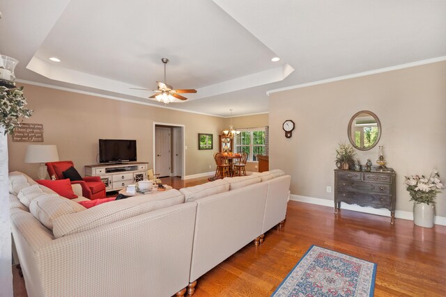 bedroom featuring baseboards, recessed lighting, wood finished floors, connected bathroom, and a raised ceiling
