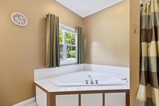 bathroom featuring a bath and baseboards