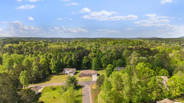 birds eye view of property with a forest view