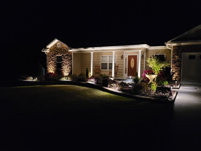view of front of property featuring stone siding and concrete driveway