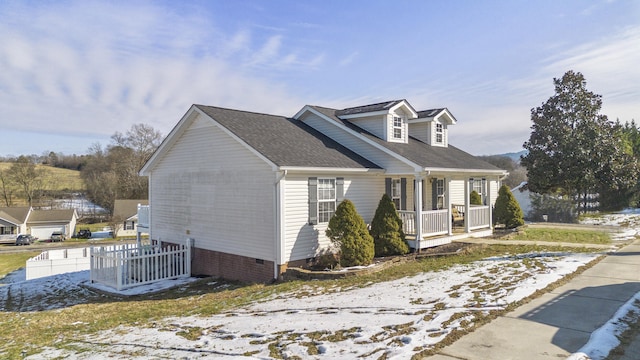 view of side of property featuring covered porch