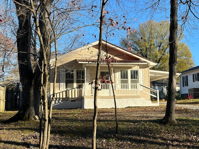 view of front of home with covered porch and a carport