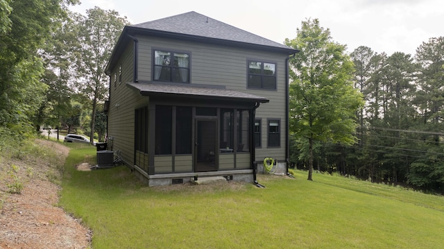 1282 No Pone Rd NW, Georgetown, TN 37336 - back of property with a sunroom, a lawn, and roof with shingles