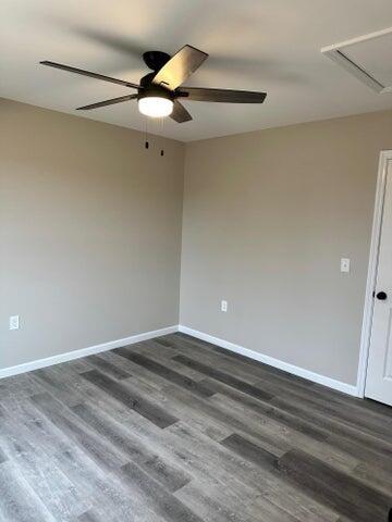 unfurnished room with dark hardwood / wood-style floors and ceiling fan