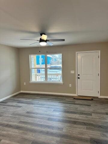 unfurnished room with dark wood-type flooring, ceiling fan, and plenty of natural light