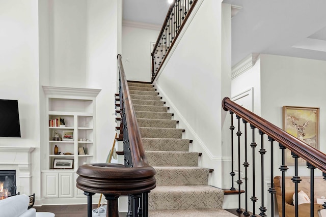 944 Ironwood Ln, Loudon, TN 37774 - stairway with built in shelves, crown molding, and hardwood / wood-style floors