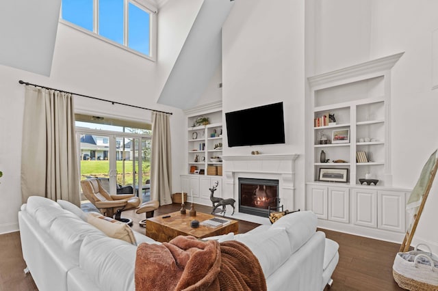 944 Ironwood Ln, Loudon, TN 37774 - living room featuring built in shelves, dark hardwood / wood-style floors, and a towering ceiling