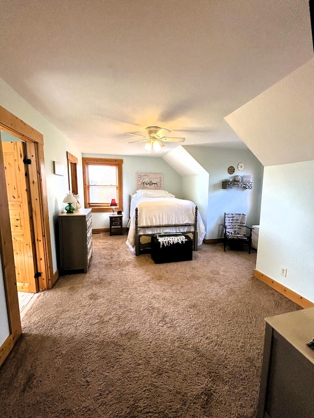 carpeted bedroom with ceiling fan, a textured ceiling, and vaulted ceiling