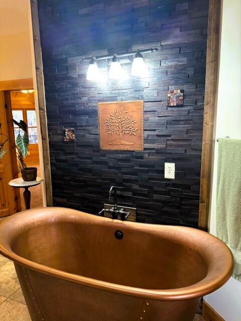 bathroom with a bathtub and tile patterned flooring