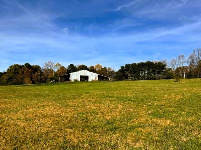 view of yard featuring an outbuilding and a rural view