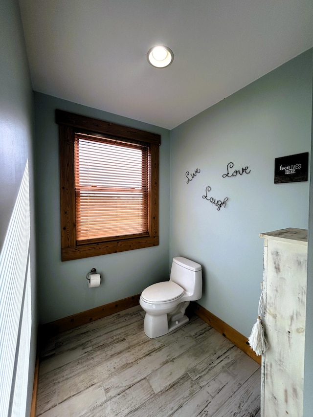 bathroom featuring hardwood / wood-style floors and toilet