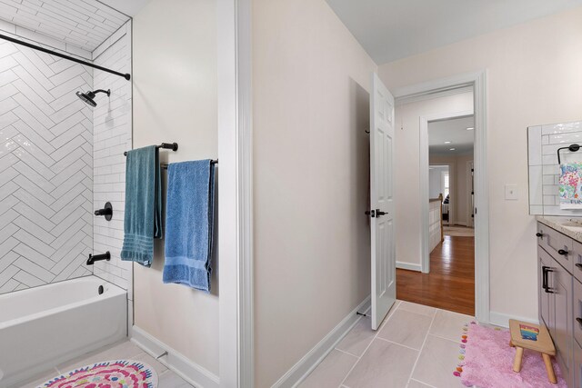 bathroom with vanity, tile patterned floors, and tiled shower / bath