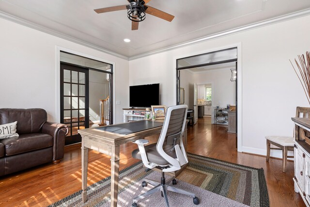 office space with ornamental molding, ceiling fan, and dark wood-type flooring