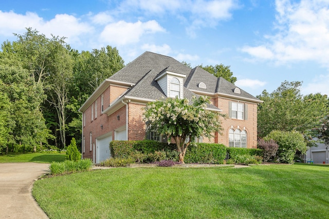 view of front of home with a front yard and a garage