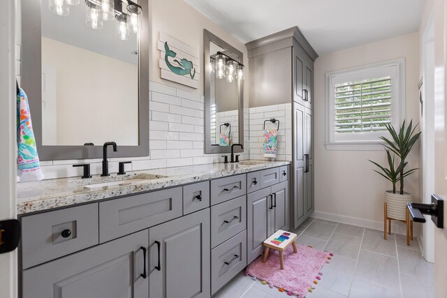 bathroom with vanity, backsplash, and tile patterned flooring