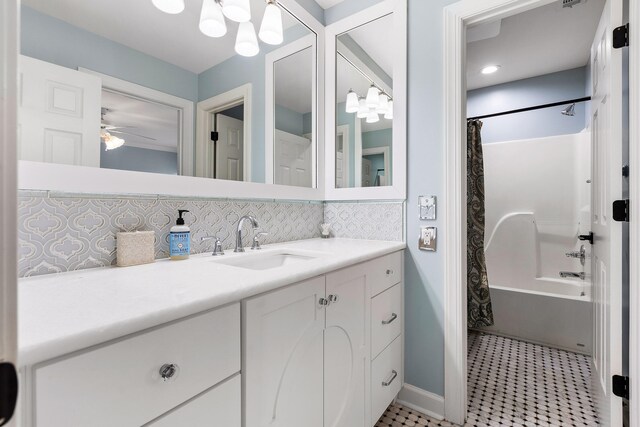 bathroom featuring tasteful backsplash, vanity, ceiling fan, shower / bathtub combination with curtain, and tile patterned flooring