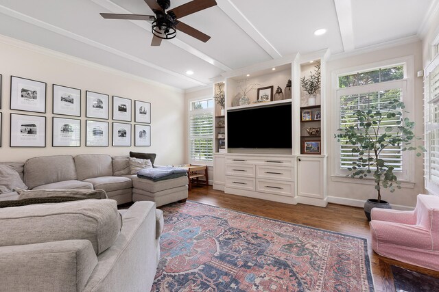 living room with dark hardwood / wood-style floors, ceiling fan, crown molding, and beam ceiling