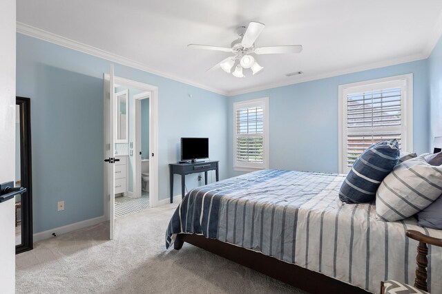 carpeted bedroom featuring ceiling fan and crown molding