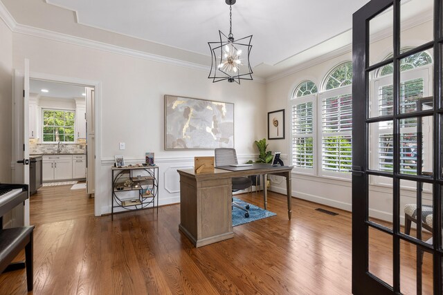 office featuring plenty of natural light, dark hardwood / wood-style flooring, and crown molding