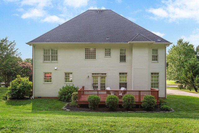 back of property featuring a lawn and a deck