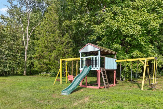 view of jungle gym featuring a lawn