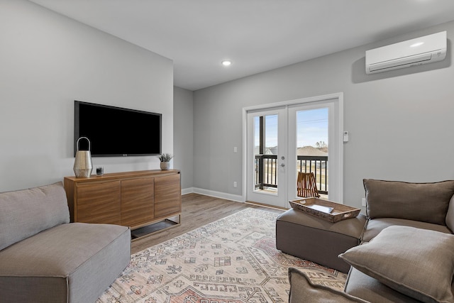 1942 Addi Ln, Chattanooga, TN 37421 - living room featuring an AC wall unit, light wood finished floors, recessed lighting, french doors, and baseboards