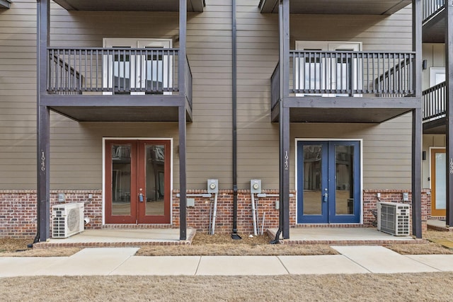 1942 Addi Ln, Chattanooga, TN 37421 - entrance to property with french doors, a balcony, brick siding, central AC unit, and a cooling unit