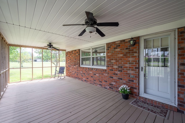 wooden deck featuring a ceiling fan