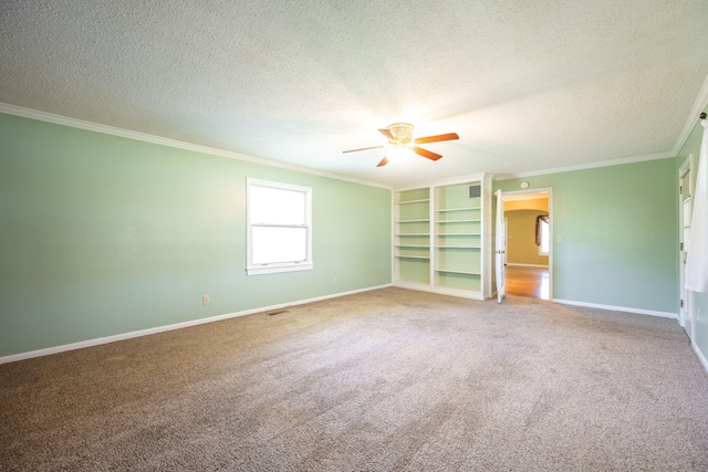 unfurnished bedroom with crown molding, carpet flooring, a textured ceiling, and baseboards