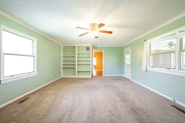 interior space featuring crown molding, ceiling fan, carpet floors, a textured ceiling, and baseboards