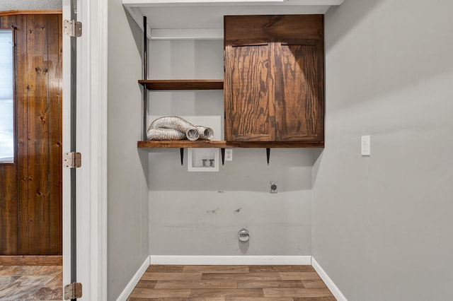 laundry room with washer hookup, electric dryer hookup, cabinets, and hardwood / wood-style flooring