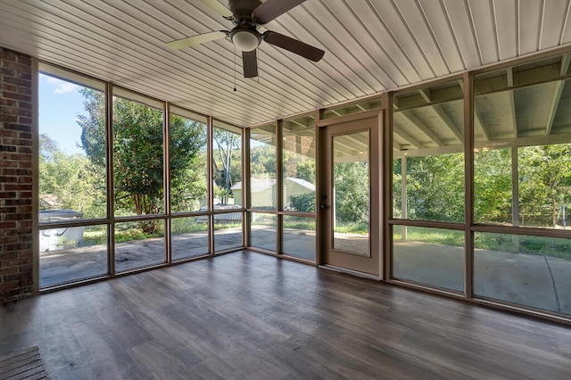 unfurnished sunroom with ceiling fan, a healthy amount of sunlight, and wooden ceiling