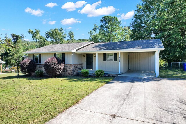 ranch-style home featuring a front yard and a carport