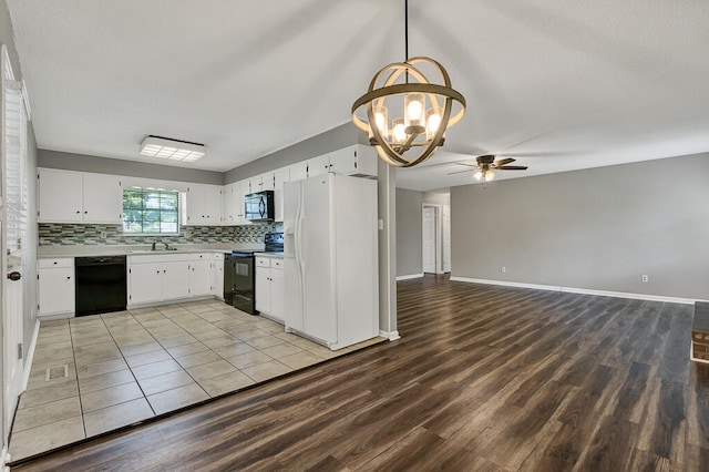 kitchen featuring black appliances, white cabinetry, light wood-type flooring, and sink