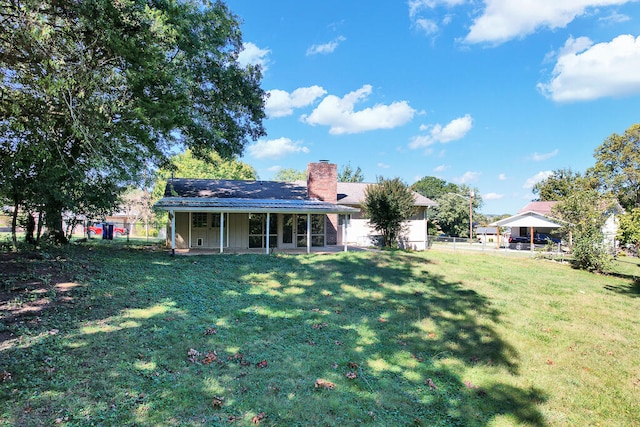 back of property with a lawn