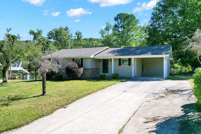 single story home with a carport and a front lawn