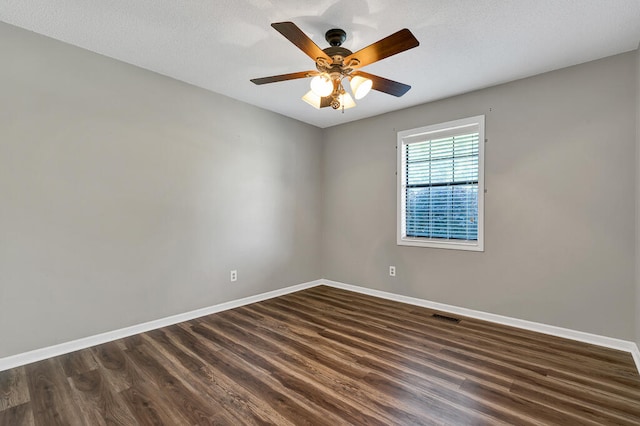 spare room with a textured ceiling, dark hardwood / wood-style flooring, and ceiling fan