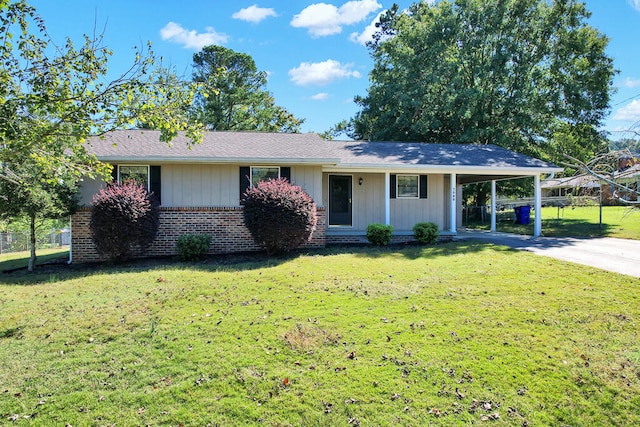 ranch-style house featuring a front lawn and a carport