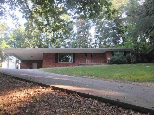 single story home featuring a front yard and a carport