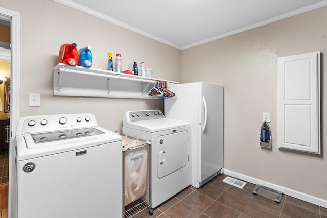 260 Sequoia Rd NW, Cleveland, TN 37312 - washroom with washing machine and clothes dryer, crown molding, and dark tile patterned flooring